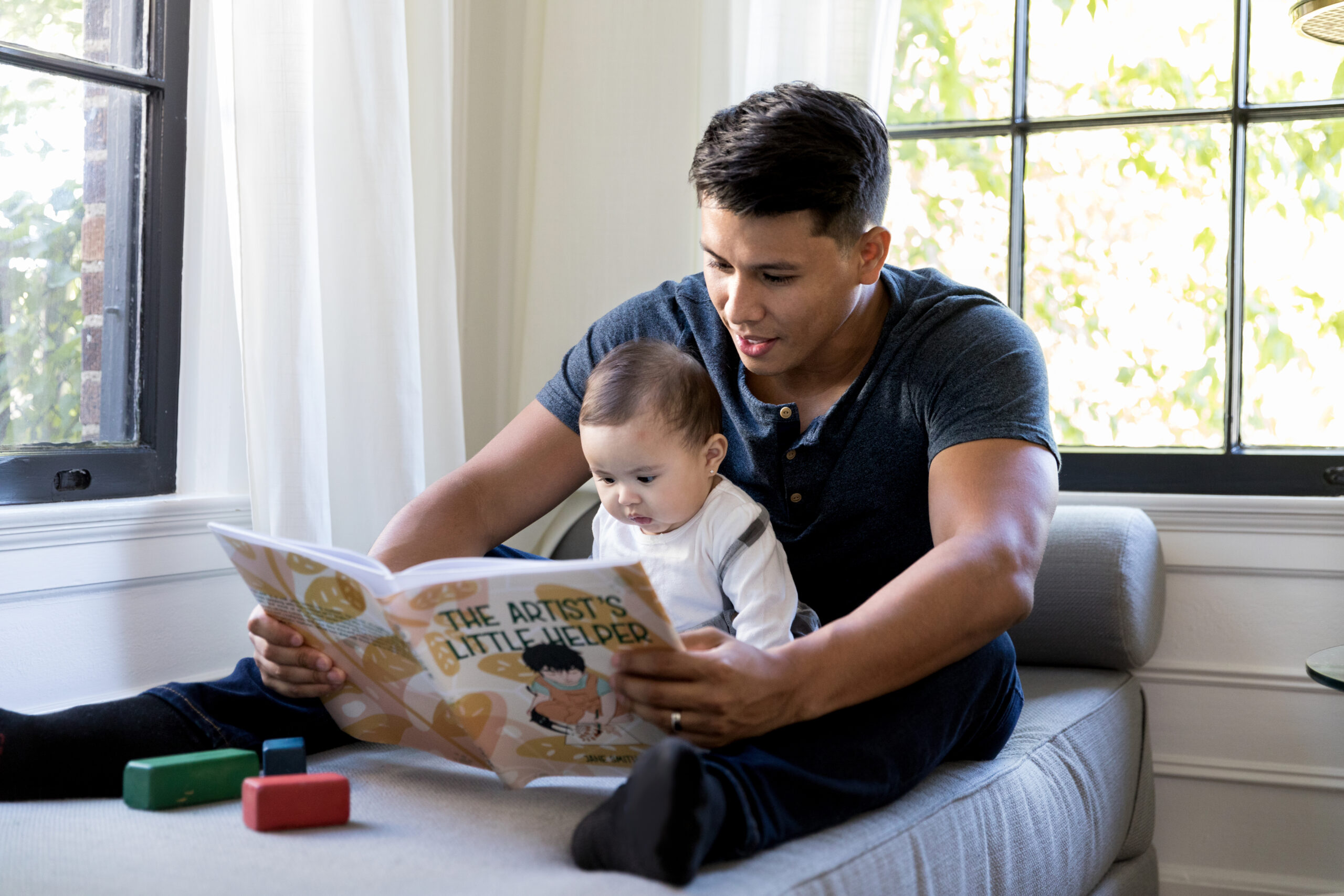 baby reading with parent