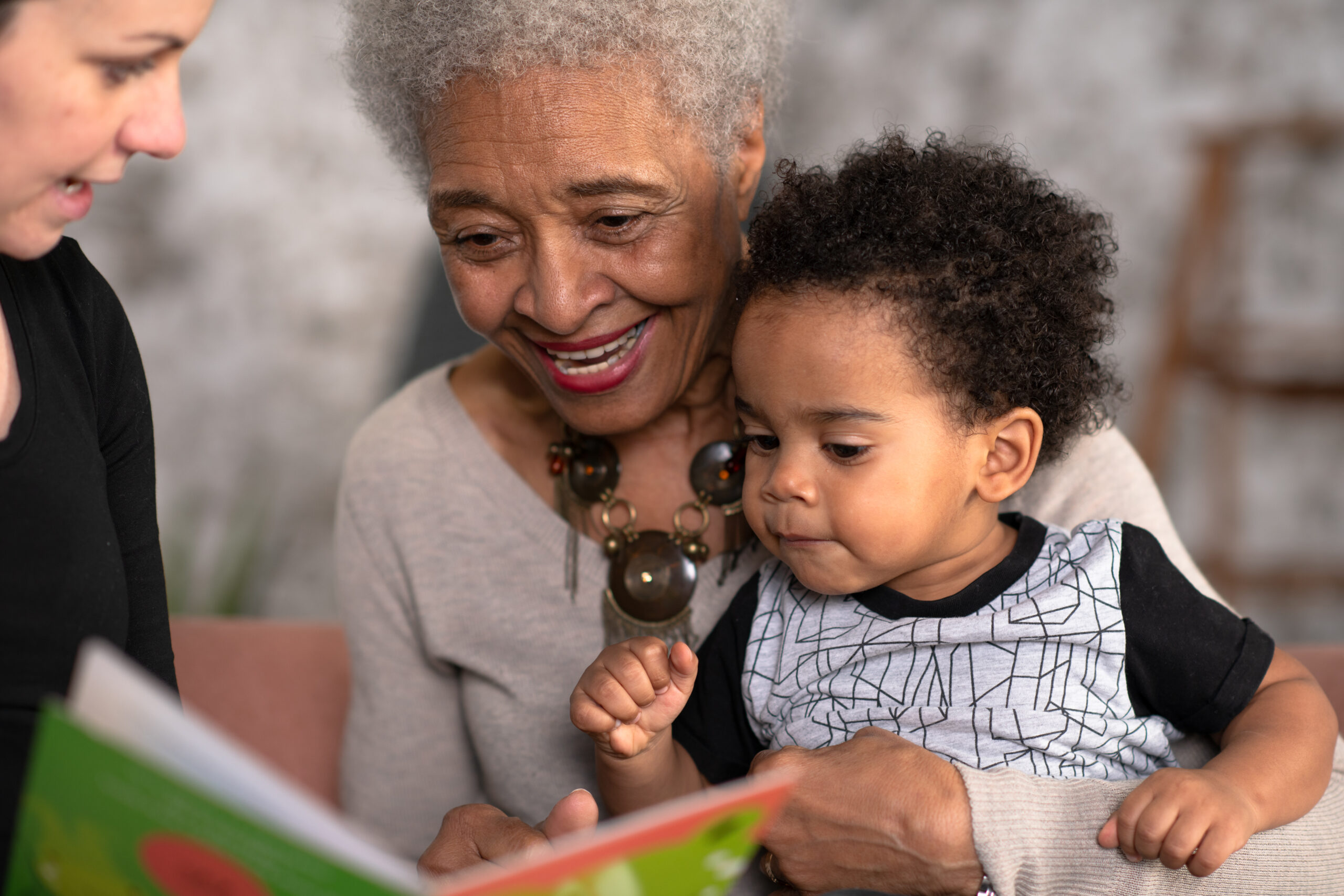 baby reading with grandma